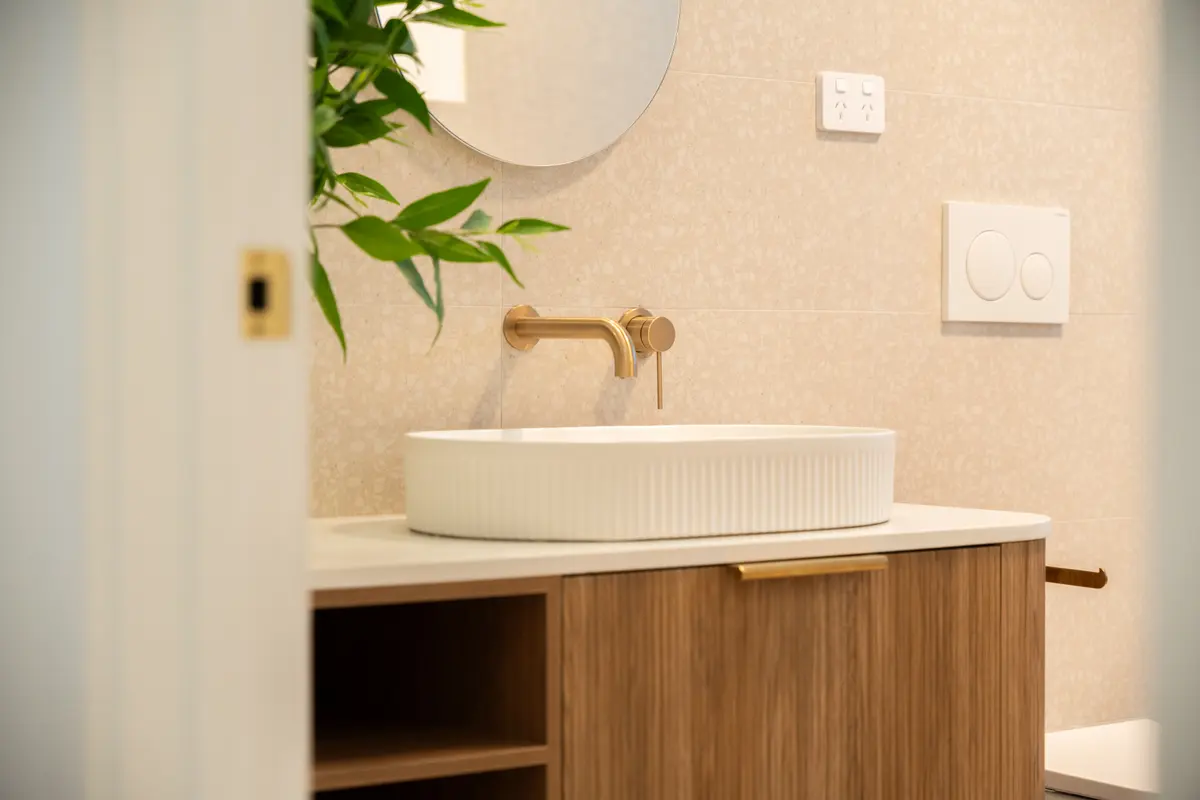 Bathroom: Curved cabinetry and a fluted basin.