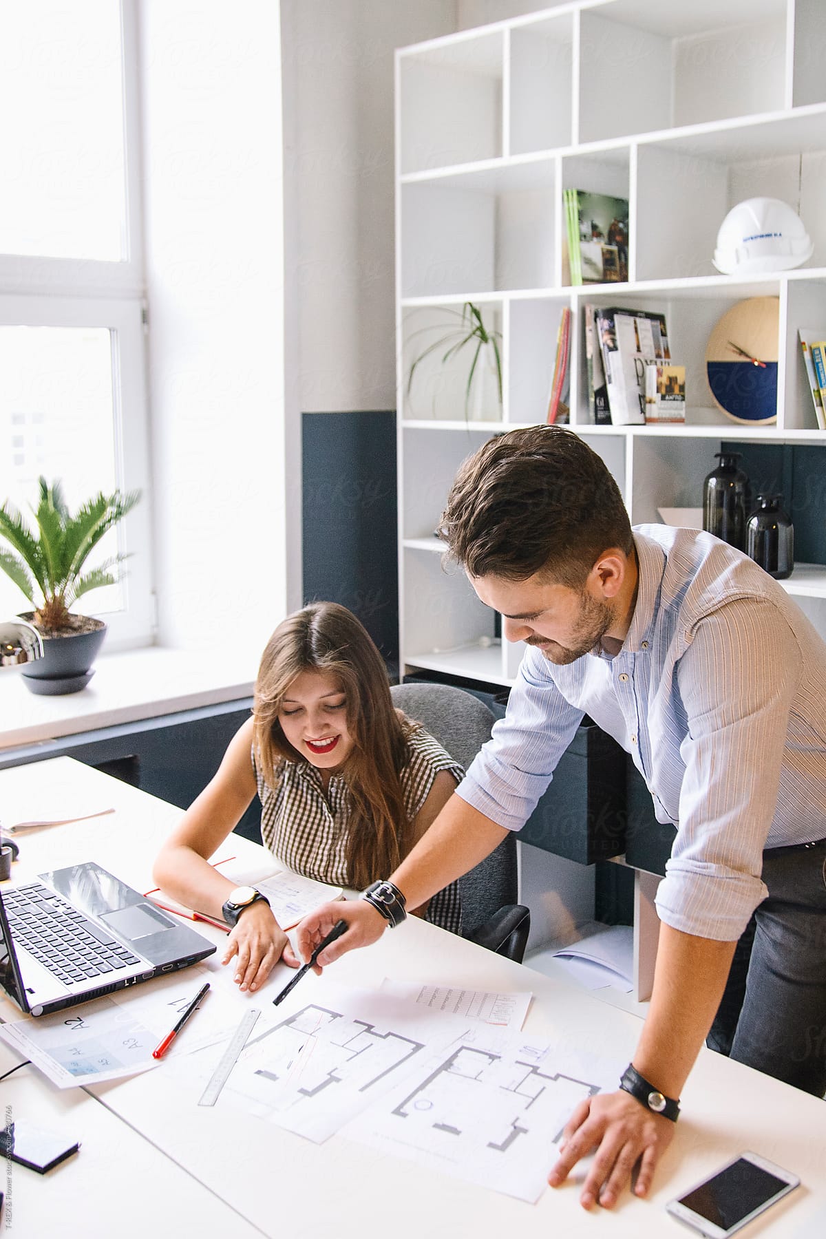 A Man And A Woman Working On A Project