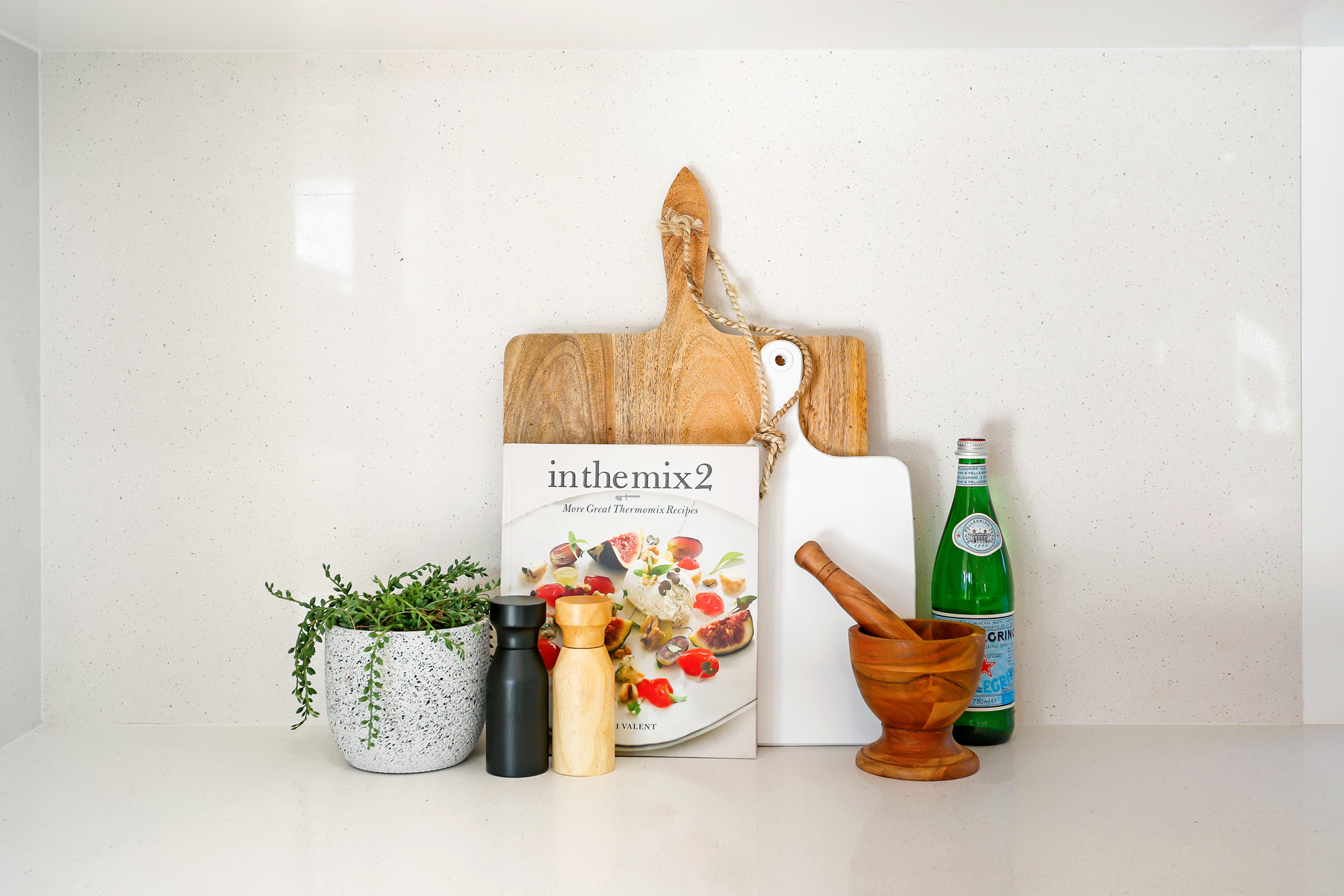 A Kitchen Counter With A Cutting Board And A Bottle Of Wine