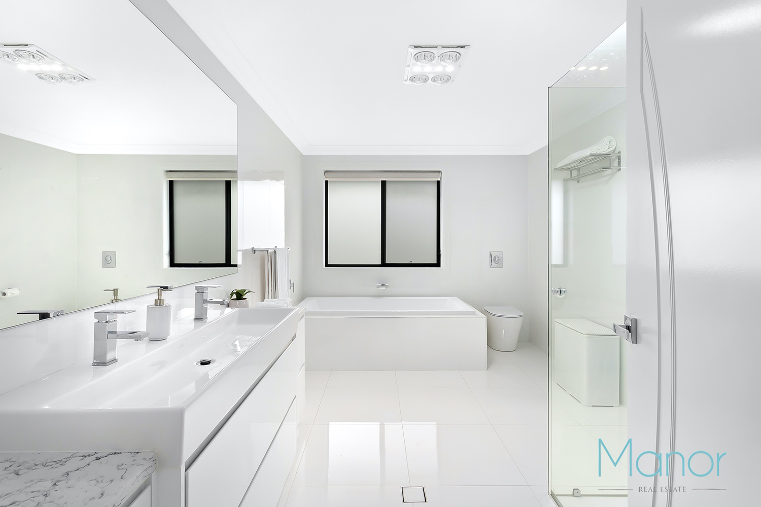 A White Bathroom With A Marble Countertop