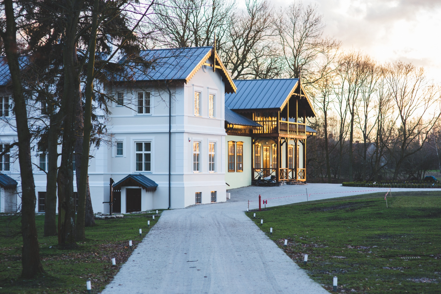 Large modern white home in forest setting