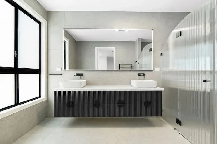 Modern bathroom with floating vanity and curved glass shower panel