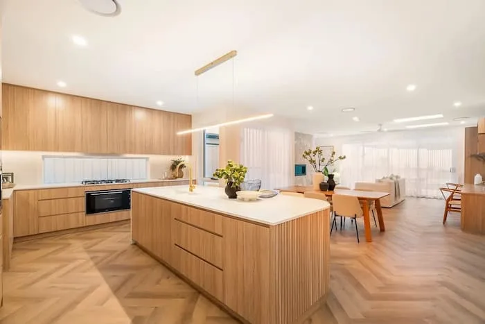 Open-concept kitchen and living area with wood and neutral tones