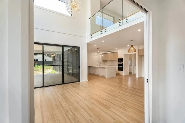Open-concept home with loft, island kitchen, and glass doors