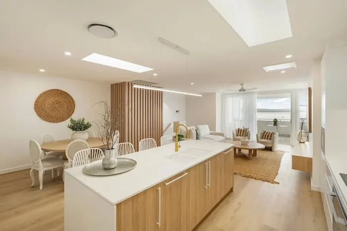Open-concept space with modern kitchen, dining, and living areas