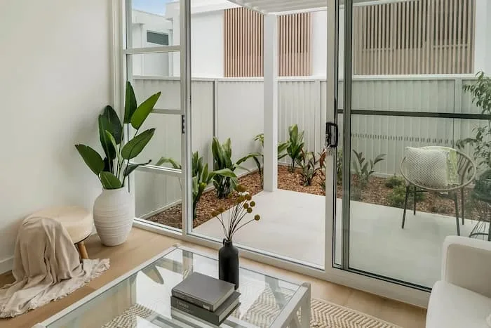 Indoor living space with glass door opening to patio and garden