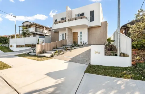 Contemporary two-story home with stone accent and flat roof